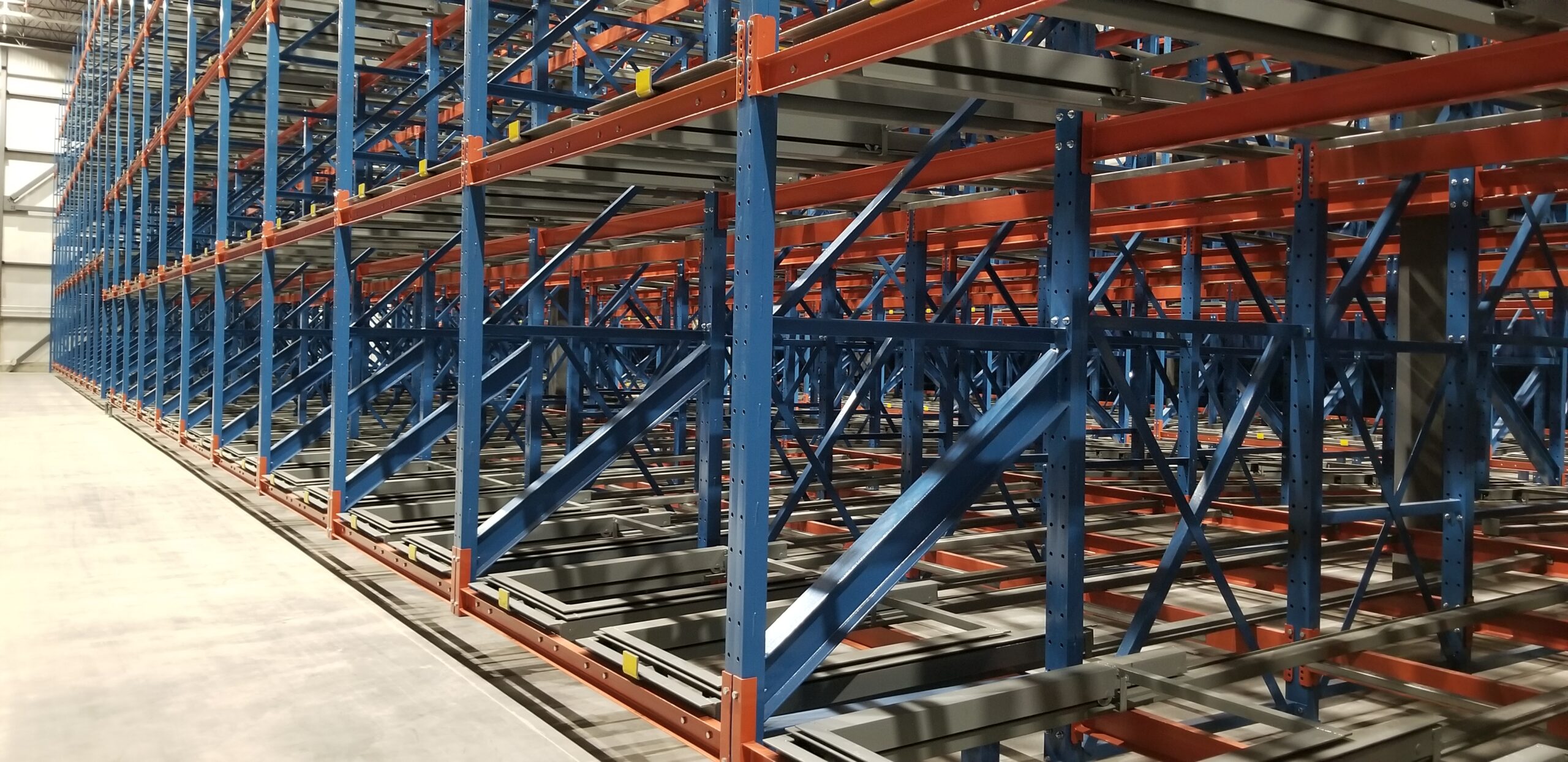 industrial-pallet-racking-solutions Pushback racking shows in a high density warehouse storage setting